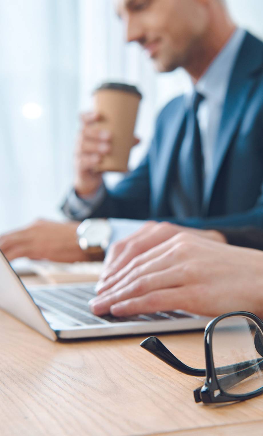 partial-view-of-businesspeople-working-on-laptops-2024-11-17-13-58-36-utc partial-view-of-businesspeople-working-on-laptops-2024-11-17-13-58-36-utc